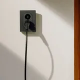 Zaptec Go 2 EV charger mounted on a house wall with a charging cable
