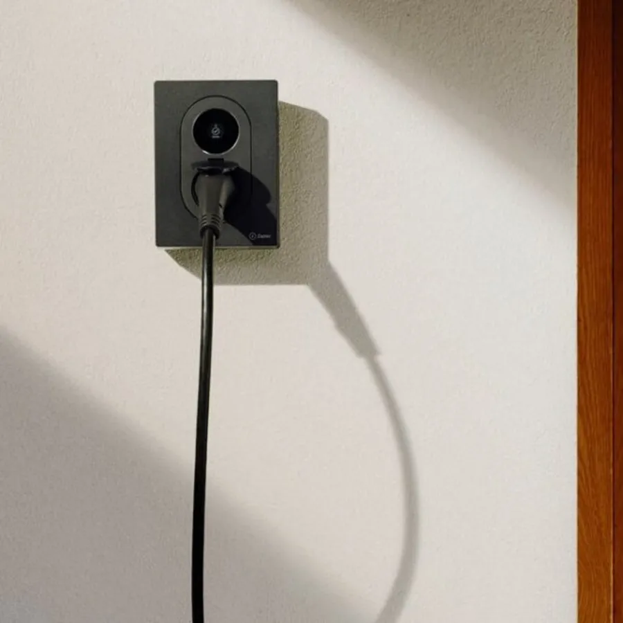 Zaptec Go 2 EV charger mounted on a house wall with a charging cable